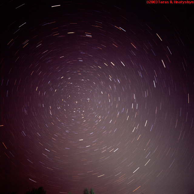 Polar star trails with plane and satellite.